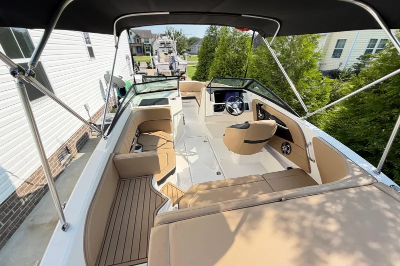 Slide: The Image of 2024 Sea Ray SPX 190 Outboard boat interior with tan seating and steering wheel. - 5