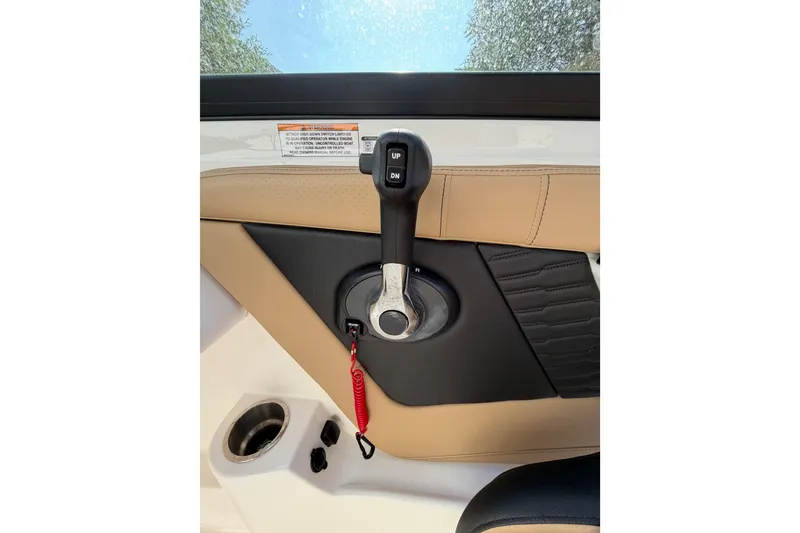 Slide: The Image of 2024 Sea Ray SPX 190 Outboard throttle control with beige and black interior accents. - 26