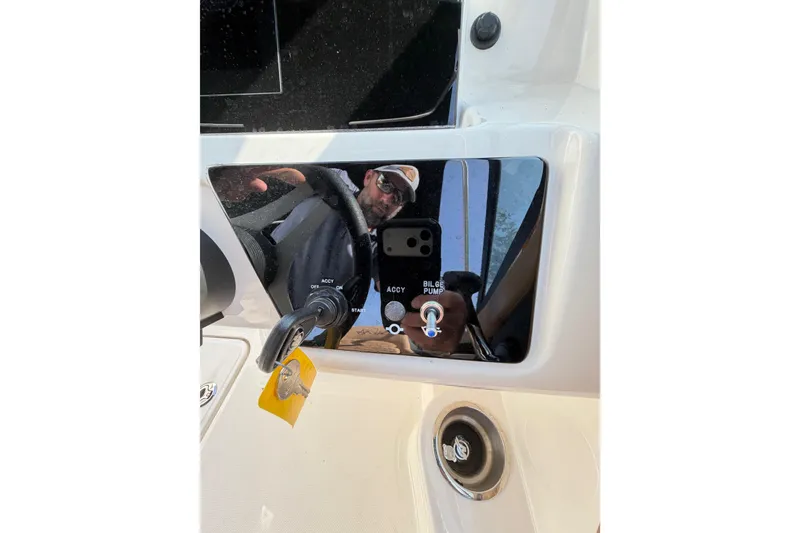 Slide: The Image of 2024 Sea Ray SPX 190 Outboard dashboard with ignition key and bilge pump switch. - 22