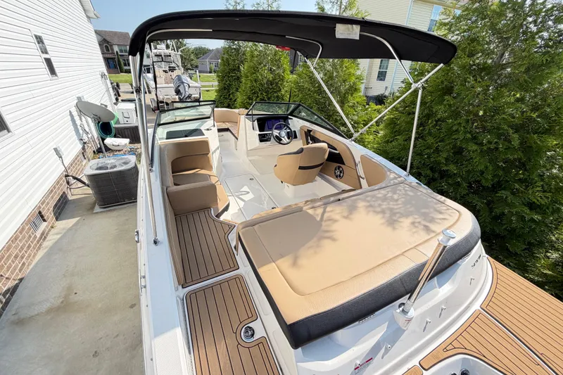 Slide: The Image of 2024 Sea Ray SPX 190 Outboard boat with tan seating and black canopy. - 4