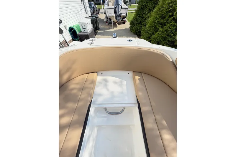 Slide: The Image of 2024 Sea Ray SPX 190 Outboard boat interior with tan seating and storage compartment. - 19