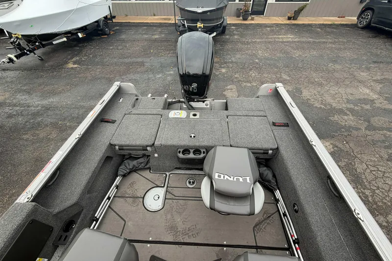Slide: The Image of 2025 Lund 1775 Impact XS Sport boat interior with seating and storage compartments. - 8