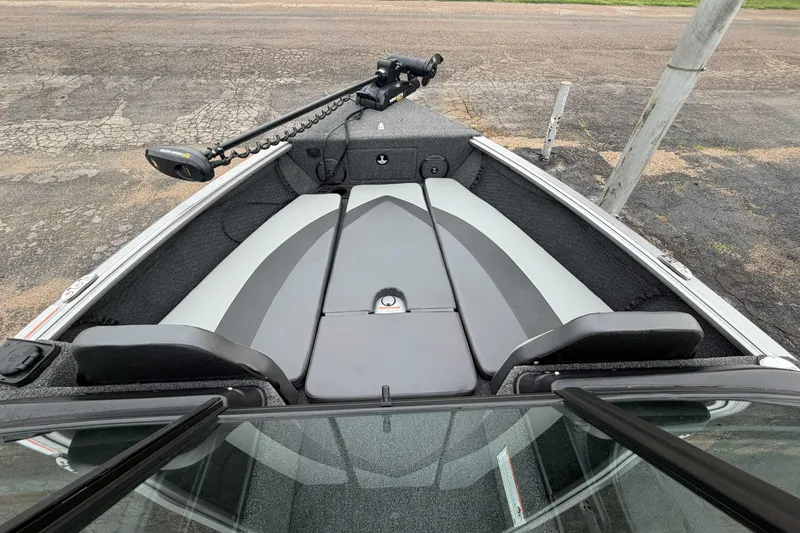 Slide: The Image of 2025 Lund 1775 Impact XS Sport boat interior with seating and trolling motor. - 4