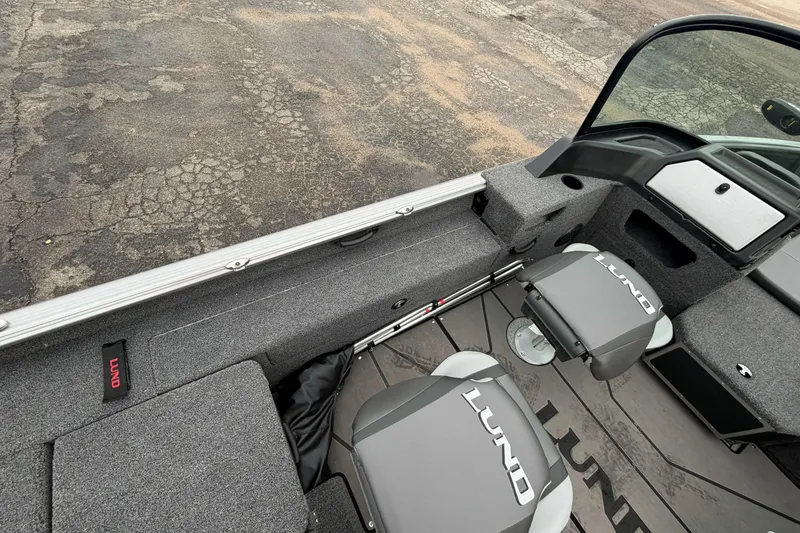 Slide: The Image of 2025 Lund 1775 Impact XS Sport boat interior with seating and storage compartments. - 7