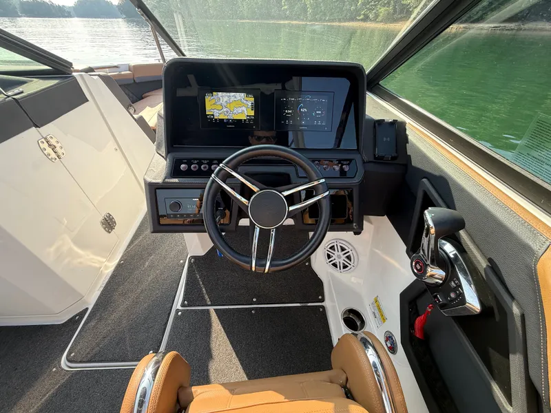 Slide: The Image of The image shows the cockpit of a 2023 Cobalt R6 Outboard with a modern helm and digital displays. - 25