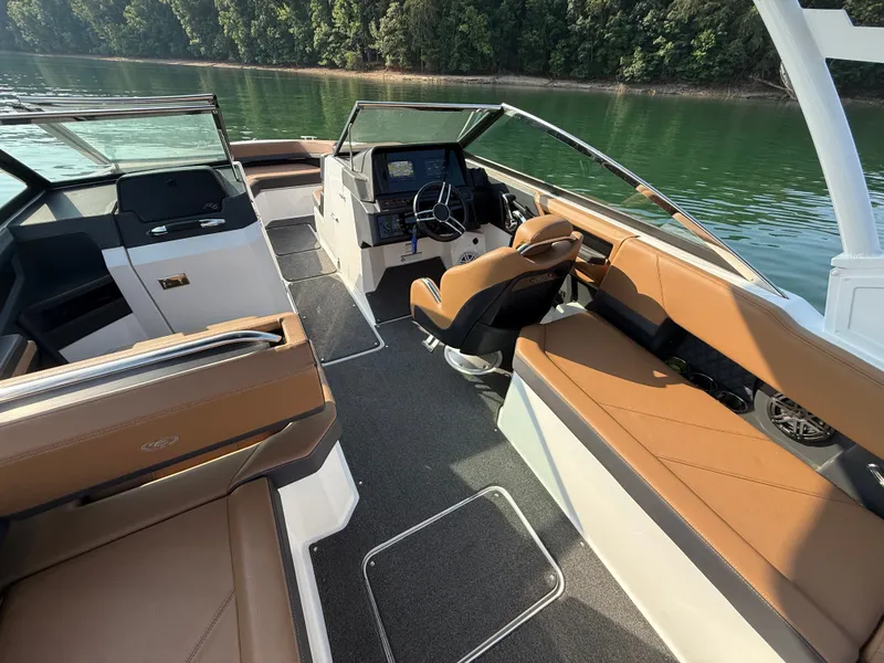 Slide: The Image of The image shows the cockpit of a 2023 Cobalt R6 Outboard with brown leather seats and a modern helm. - 21