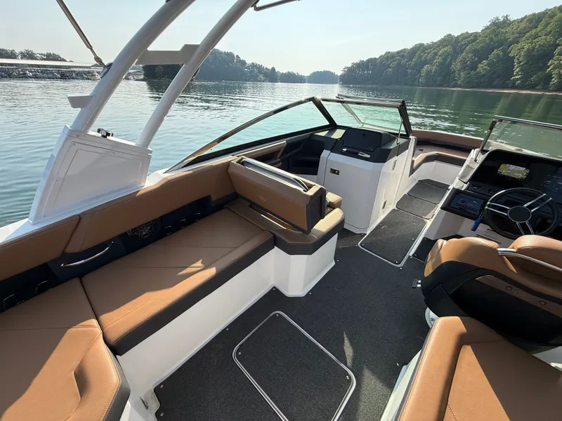 Slide: The Image of The image shows the interior of a 2023 Cobalt R6 Outboard boat with brown seating. - 20