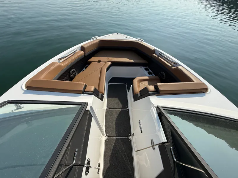 Slide: The Image of The image shows the bow of a 2023 Cobalt R6 Outboard with brown upholstery and black carpeting. - 34