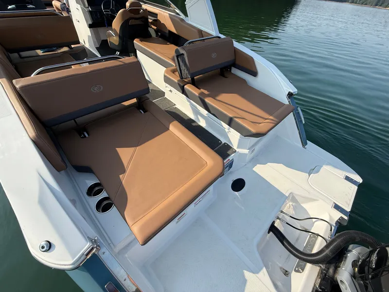Slide: The Image of The image shows the stern of a 2023 Cobalt R6 Outboard boat with brown upholstery. - 16