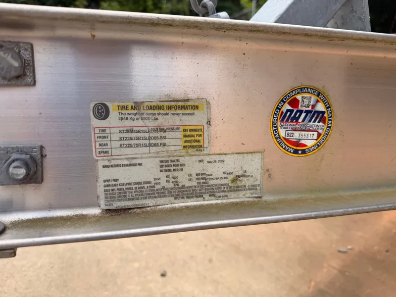 Slide: The Image of Close-up of a boat trailer with stickers and tire loading information. - 42