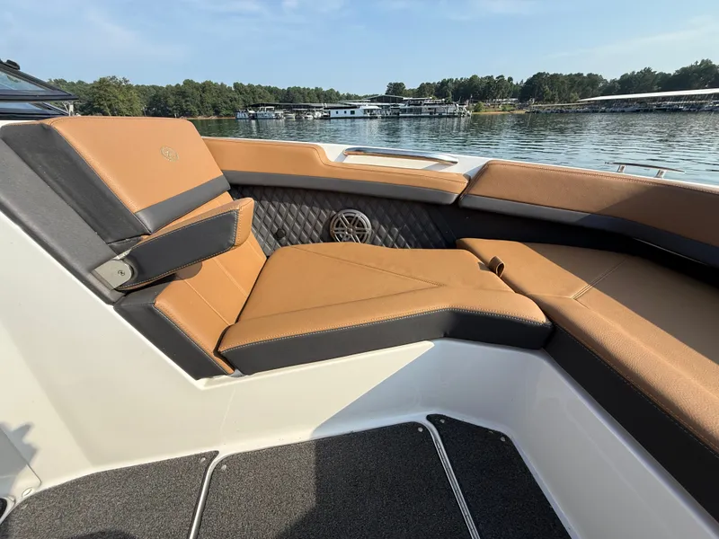 Slide: The Image of The image shows the cockpit of a 2023 Cobalt R6 Outboard boat with brown upholstery. - 36
