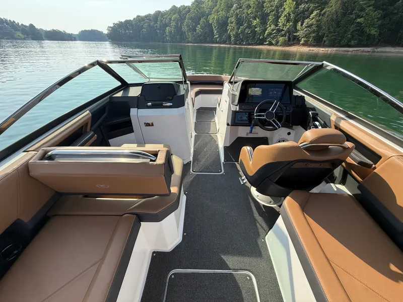 Slide: The Image of The image shows the cockpit of a 2023 Cobalt R6 Outboard with brown leather seats and a modern helm. - 24