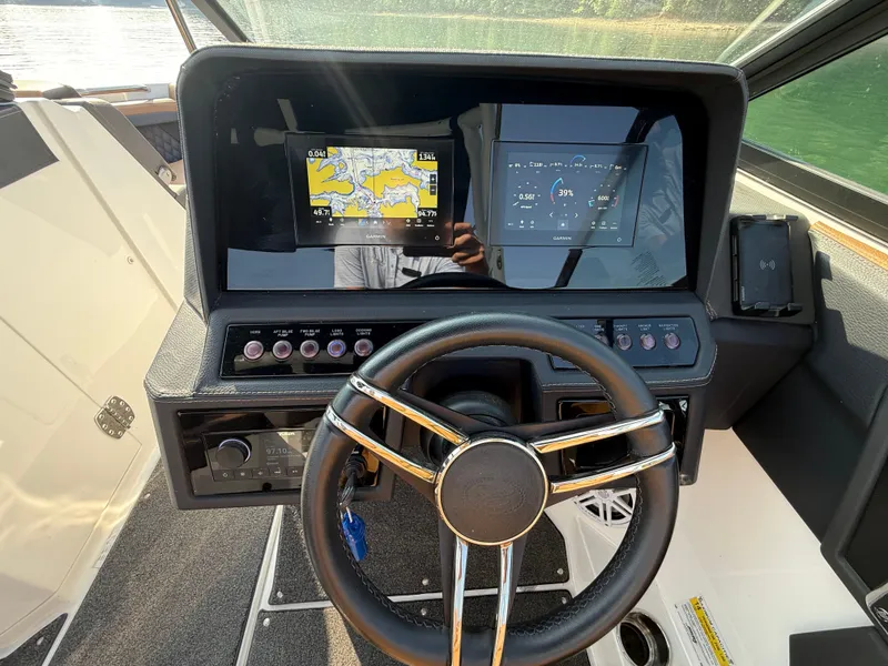 Slide: The Image of The cockpit of the 2023 Cobalt R6 Outboard features a modern dashboard with two screens. - 26