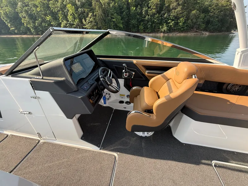 Slide: The Image of The image shows the cockpit of a 2023 Cobalt R6 Outboard with brown leather seats and a modern helm. - 28