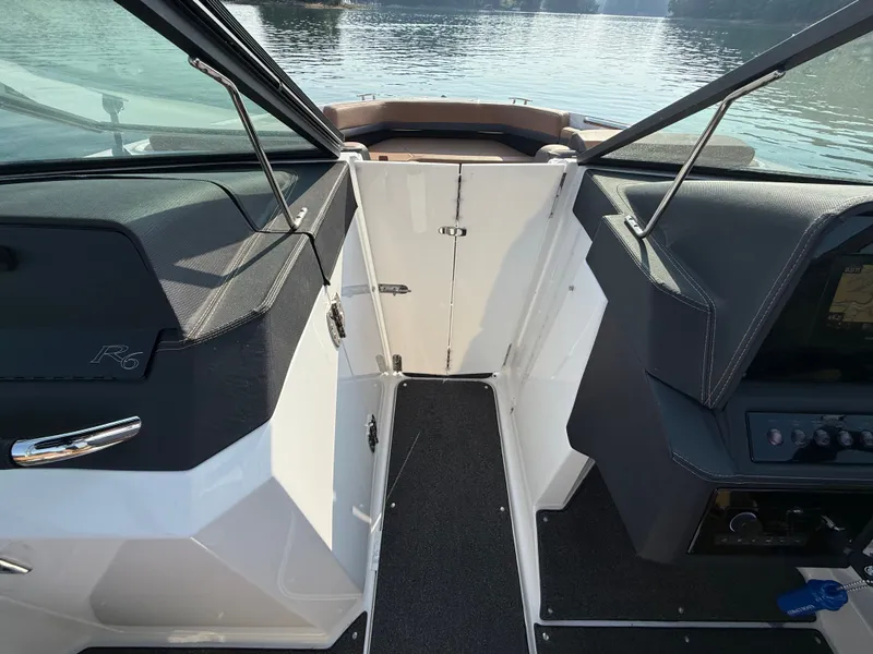 Slide: The Image of The image shows the cockpit of a 2023 Cobalt R6 Outboard with black and white interior. - 33