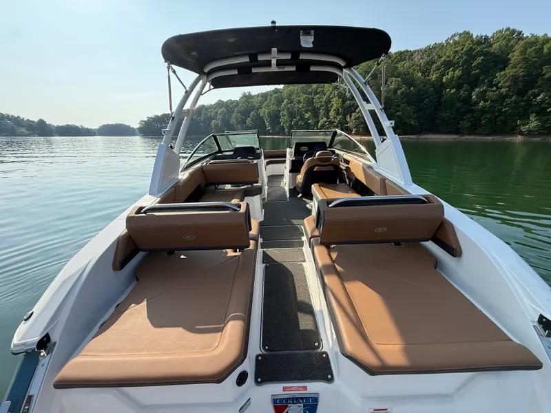 Slide: The Image of The image shows a 2023 Cobalt R6 Outboard boat on a calm lake. - 38