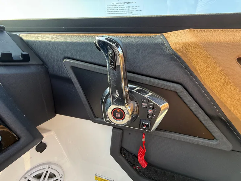 Slide: The Image of Close-up of the throttle lever on a Cobalt R6 Outboard boat, surrounded by black and brown upholstery. - 29