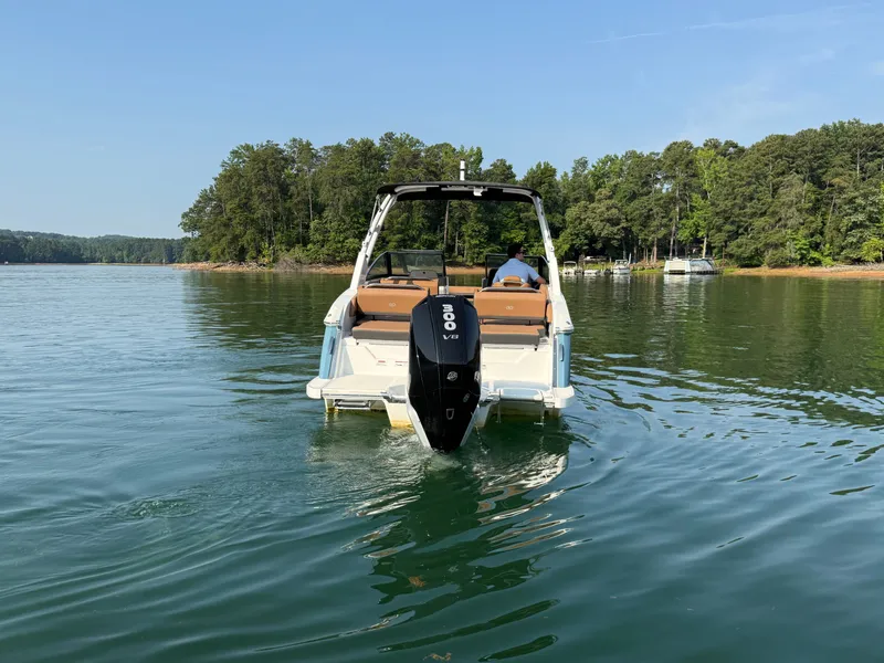 Slide: The Image of A 2023 Cobalt R6 Outboard on a calm lake, surrounded by trees. - 13