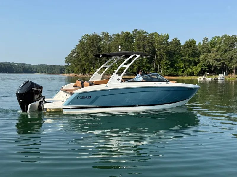 Slide: The Image of A 2023 Cobalt R6 Outboard cruising on a calm lake with a wooded shoreline. - 39