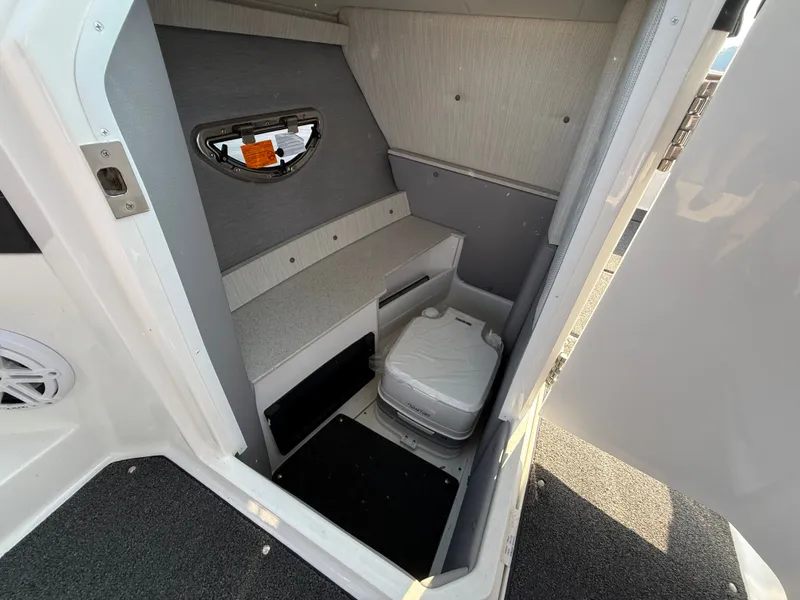 Slide: The Image of The image shows the interior of a boat with a small toilet and sink area. - 31