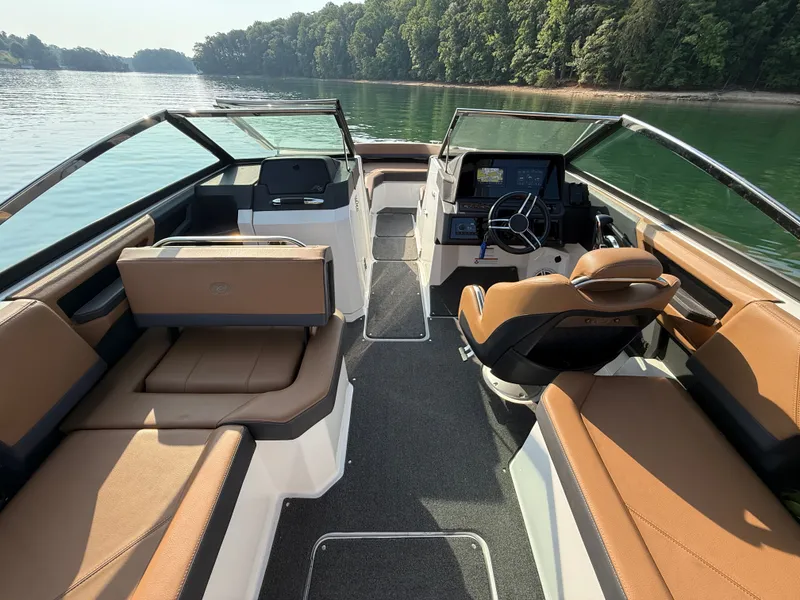 Slide: The Image of The image shows the interior of a 2023 Cobalt R6 Outboard boat with brown seating and a modern helm. - 23