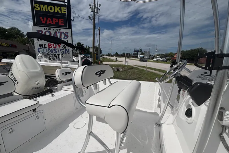 Slide: The Image of 2020 Glasstream 20 CCR boat interior with Suzuki engine, parked near a road. - 15
