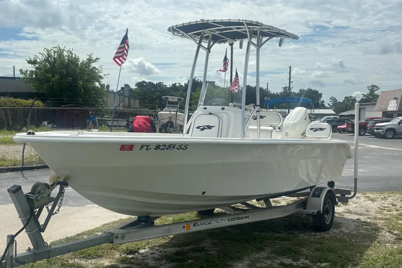 Slide: The Image of 2020 Glasstream 20 CCR boat on trailer, parked outdoors with American flags in background. - 4