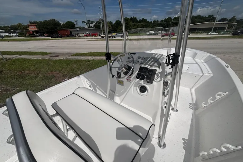 Slide: The Image of 2020 Glasstream 20 CCR boat interior with steering console and seating, parked outdoors. - 17