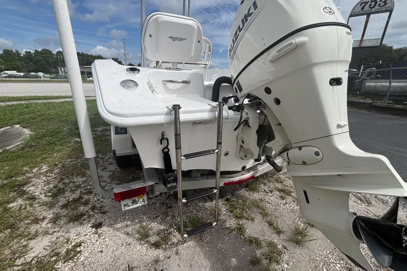 Slide: The Image of 2020 Glasstream 20 CCR boat with Suzuki outboard motor and ladder, parked on gravel. - 22