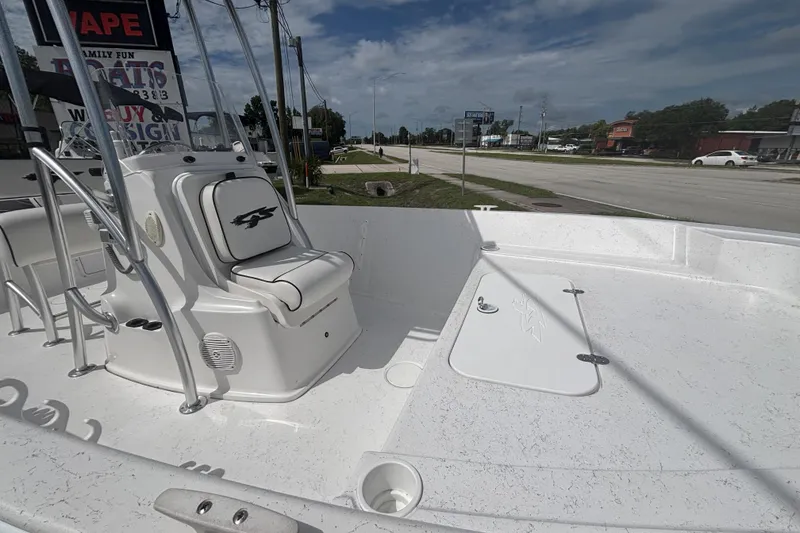 Slide: The Image of 2020 Glasstream 20 CCR boat interior with seating and storage, parked near a road. - 12
