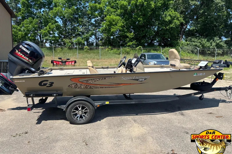 Slide: The Image of 2021 G3 Sportsman 1810 boat with Yamaha engine on trailer, parked outdoors. - 2