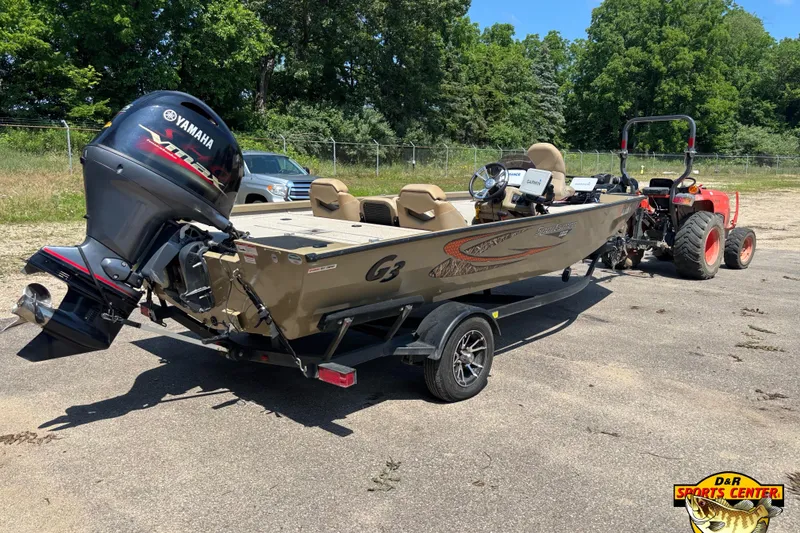 Slide: The Image of 2021 G3 Sportsman 1810 boat with Yamaha motor, parked outdoors, attached to a tractor. - 3