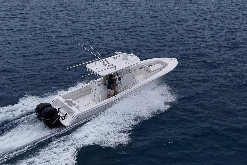 Slide: The Image of 2018 Invincible 33 Open Fisherman boat cruising on open ocean waters. - 11