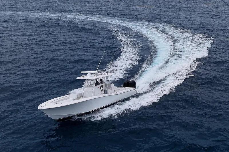 Slide: The Image of 2018 Invincible 33 Open Fisherman boat cruising on open ocean waters. - 2