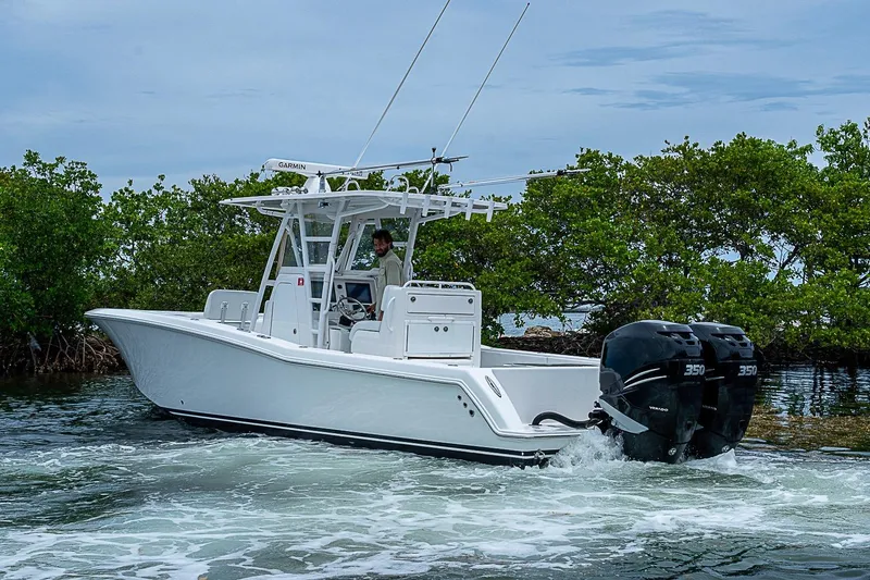 Slide: The Image of 2018 Invincible 33 Open Fisherman boat navigating through mangroves with twin 350 engines. - 45