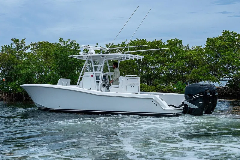 Slide: The Image of 2018 Invincible 33 Open Fisherman boat cruising near lush green mangroves. - 46