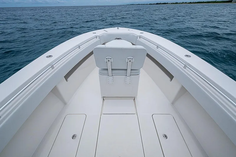 Slide: The Image of 2018 Invincible 33 Open Fisherman boat on open water, showcasing spacious deck design. - 14