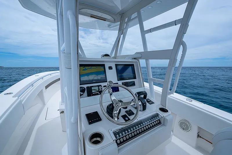 Slide: The Image of 2018 Invincible 33 Open Fisherman boat dashboard with ocean view. - 34