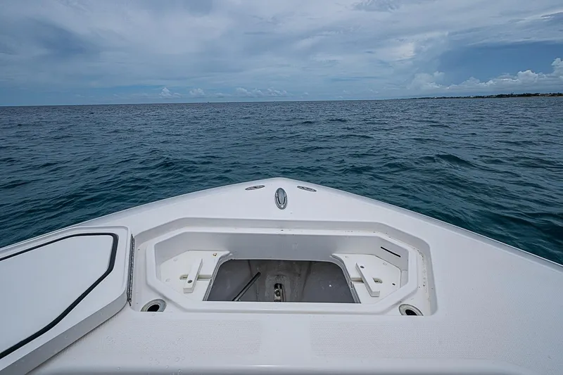 Slide: The Image of Bow view of 2018 Invincible 33 Open Fisherman on open sea under cloudy sky. - 20