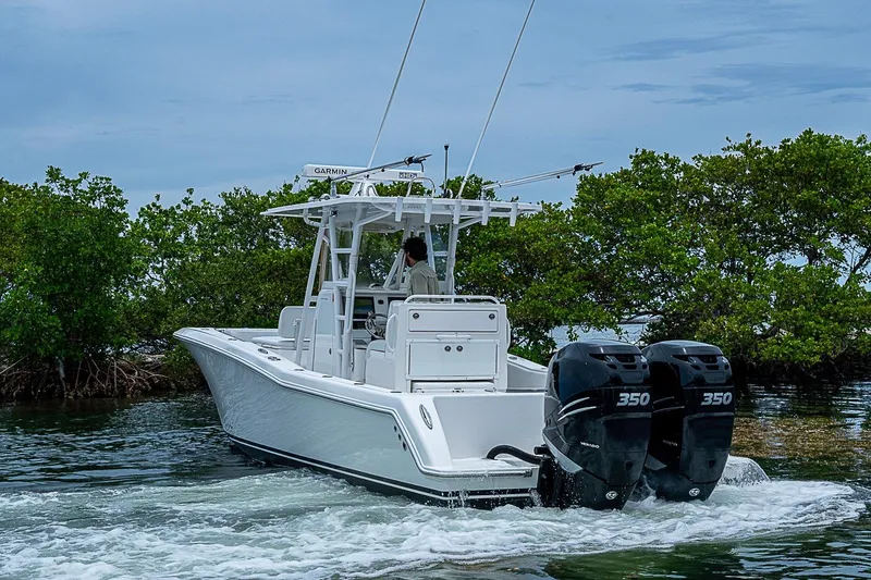 Slide: The Image of 2018 Invincible 33 Open Fisherman boat with dual 350 engines navigating through water. - 44