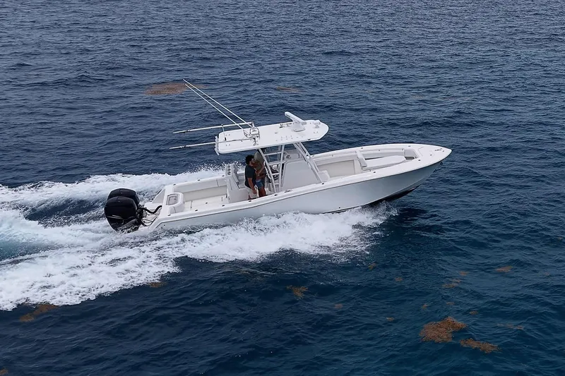 Slide: The Image of 2018 Invincible 33 Open Fisherman boat cruising on open ocean waters. - 7