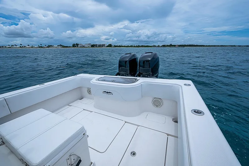 Slide: The Image of 2018 Invincible 33 Open Fisherman boat on open water, featuring dual engines and spacious deck. - 24