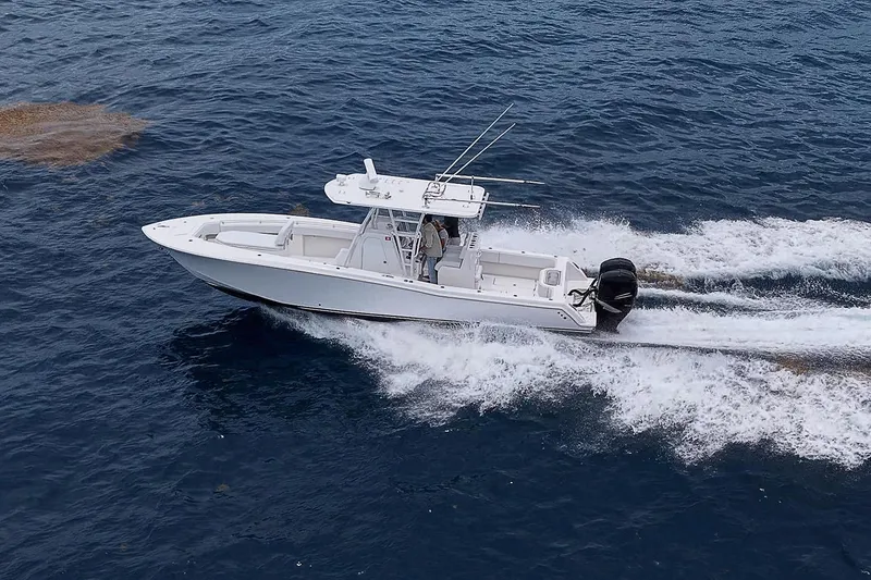 Slide: The Image of 2018 Invincible 33 Open Fisherman cruising on open water, showcasing sleek design and performance. - 9