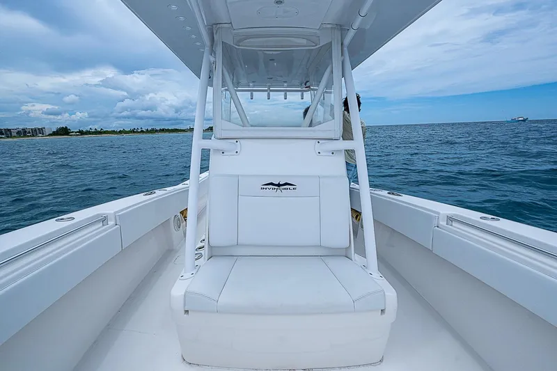 Slide: The Image of 2018 Invincible 33 Open Fisherman boat on open water, showcasing sleek design and spacious seating. - 22