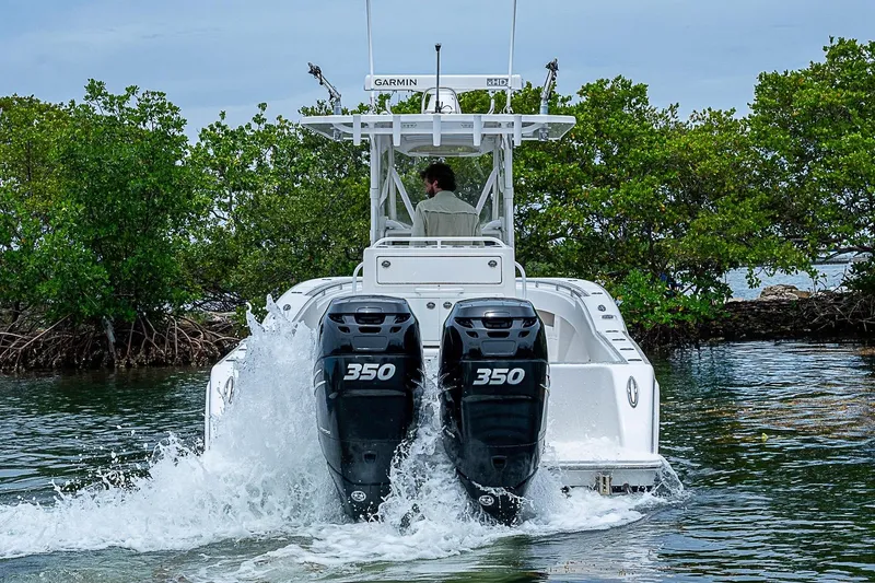 Slide: The Image of 2018 Invincible 33 Open Fisherman boat with dual 350 engines navigating through water. - 43