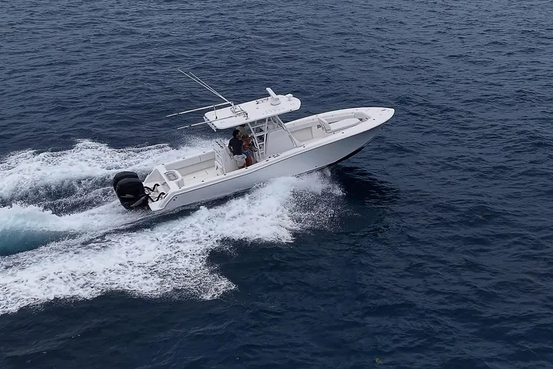 Slide: The Image of 2018 Invincible 33 Open Fisherman boat cruising on open water. - 12