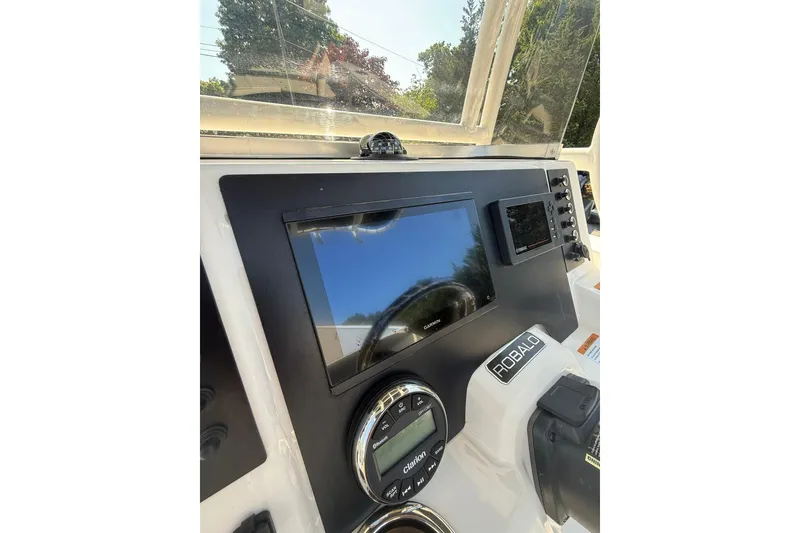 Slide: The Image of 2022 Robalo R200 Center Console dashboard with Garmin display and controls. - 14