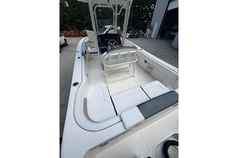 Slide: The Image of 2022 Robalo R200 Center Console boat interior with seating and steering console. - 5