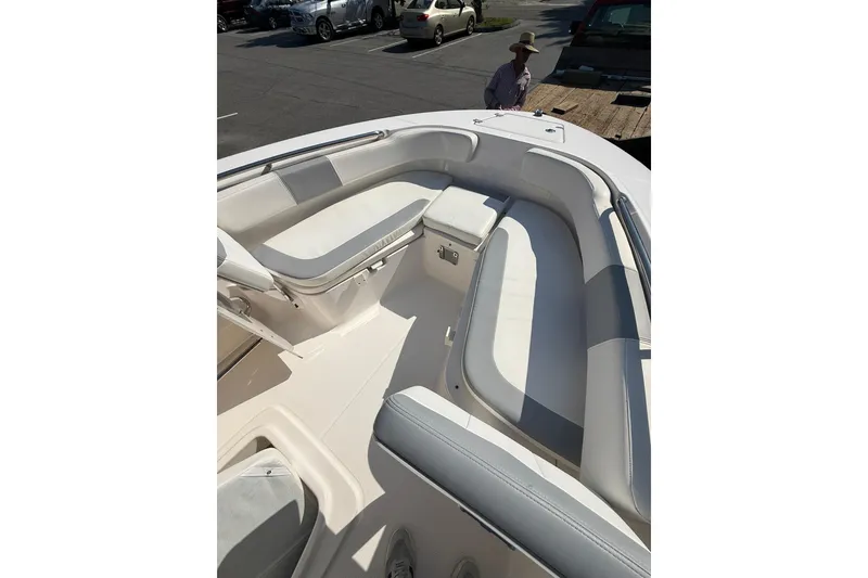 Slide: The Image of 2022 Robalo R200 Center Console boat with spacious seating in a parking lot. - 20