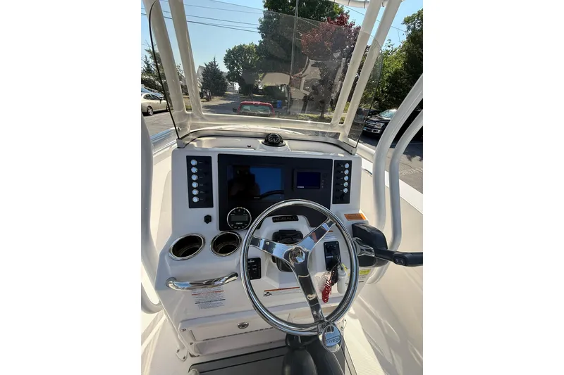 Slide: The Image of 2022 Robalo R200 Center Console boat dashboard with steering wheel and controls. - 12